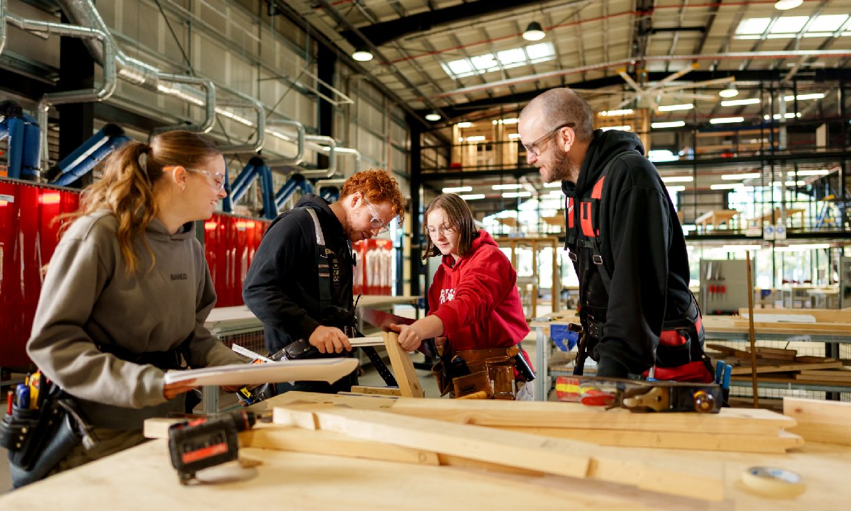People woodworking in a workshop. 