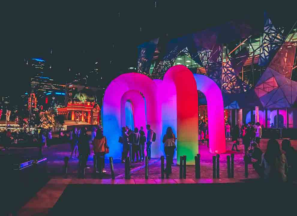 neon lights and illuminated structures in Federation Square, Melbourne.