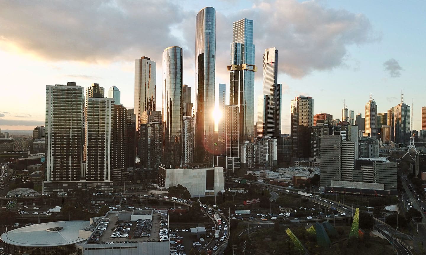 View of Melbourne CBD with the sun setting between buildings