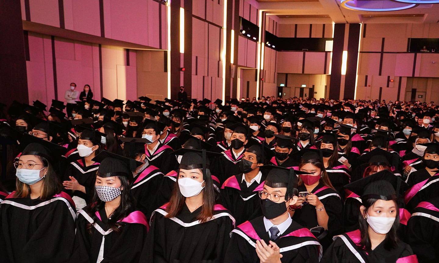 A class of graduates in a hall at the SIM graduation ceremony