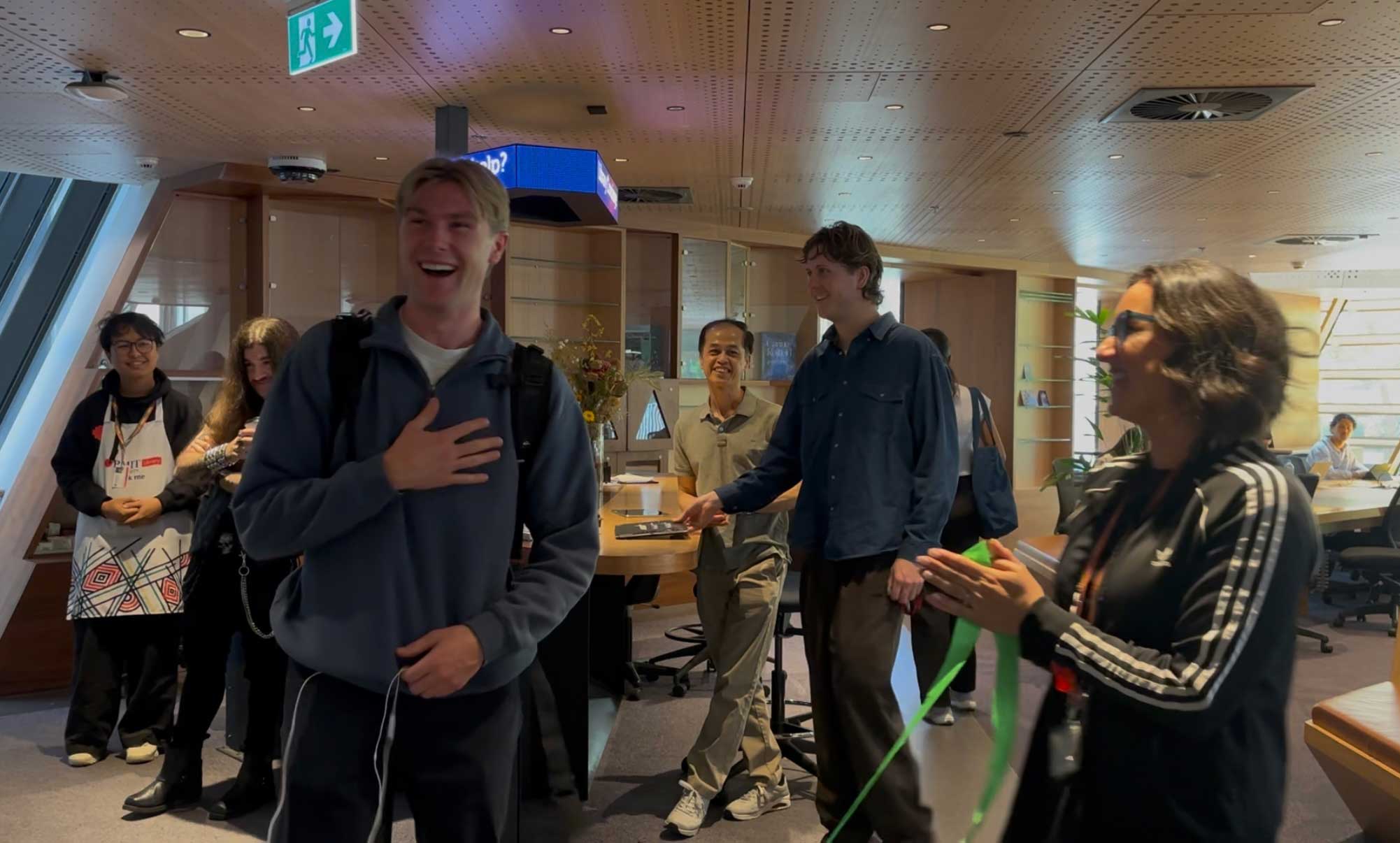 Lachlan looks surprised and happy to be informed he's the millionth visitor