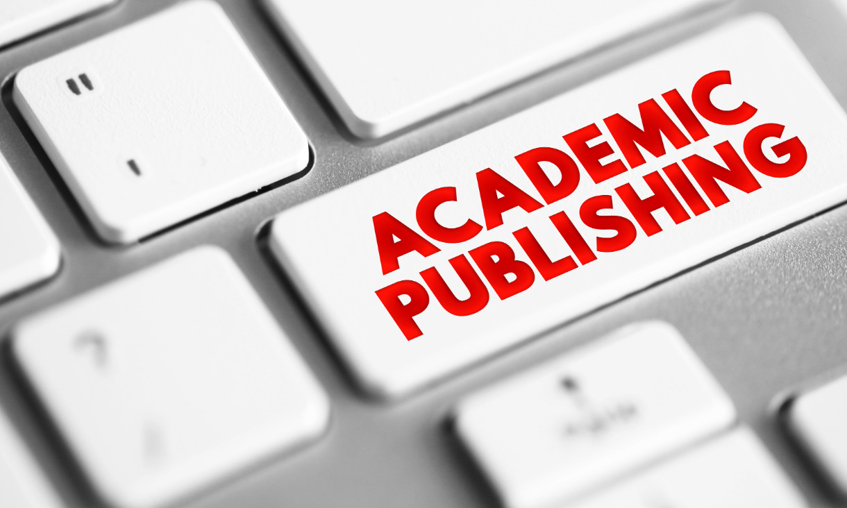 White keyboard with the words 'academic publishing' on the enter key