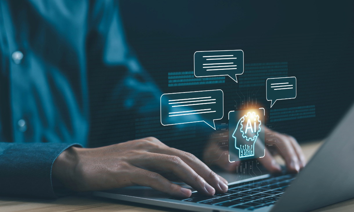 Person types on laptop with AI bubbles appearing