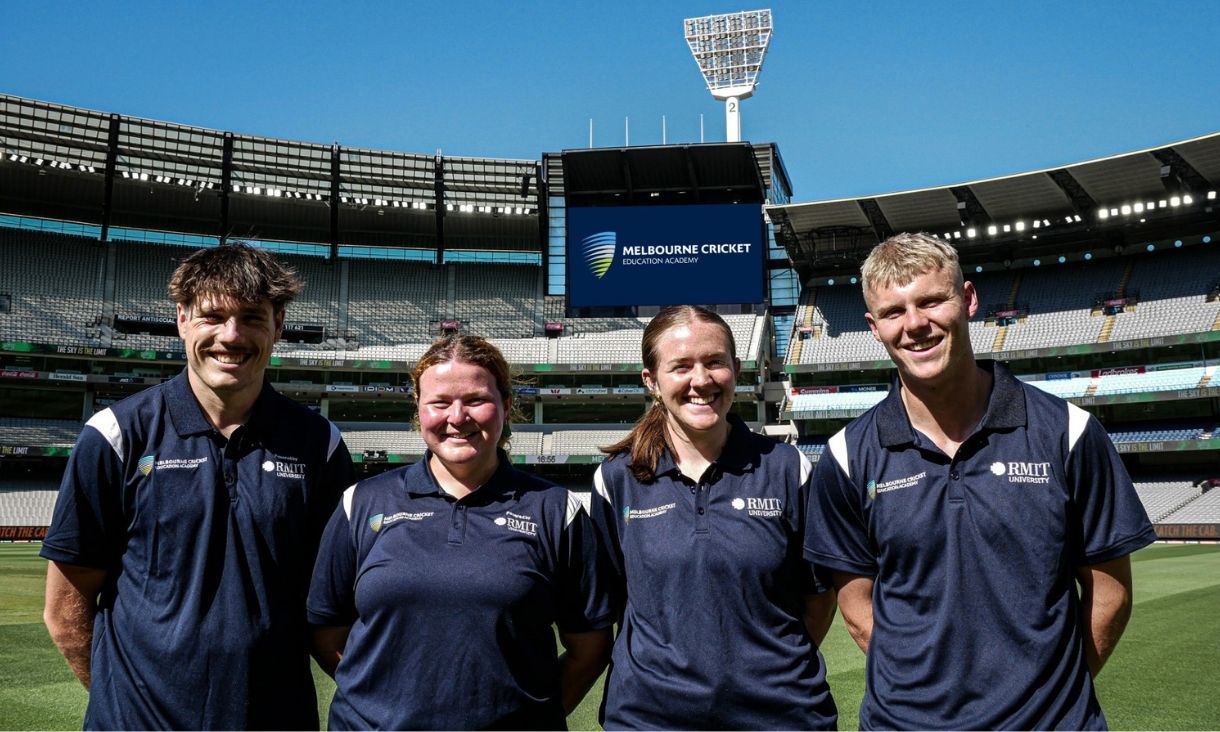 4 students standing on the MCG grounds