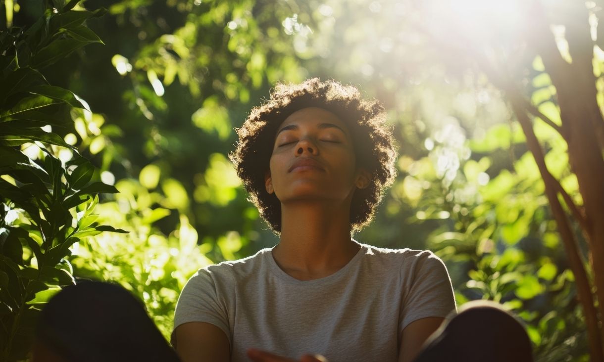 Someone sitting peacefully in a green space