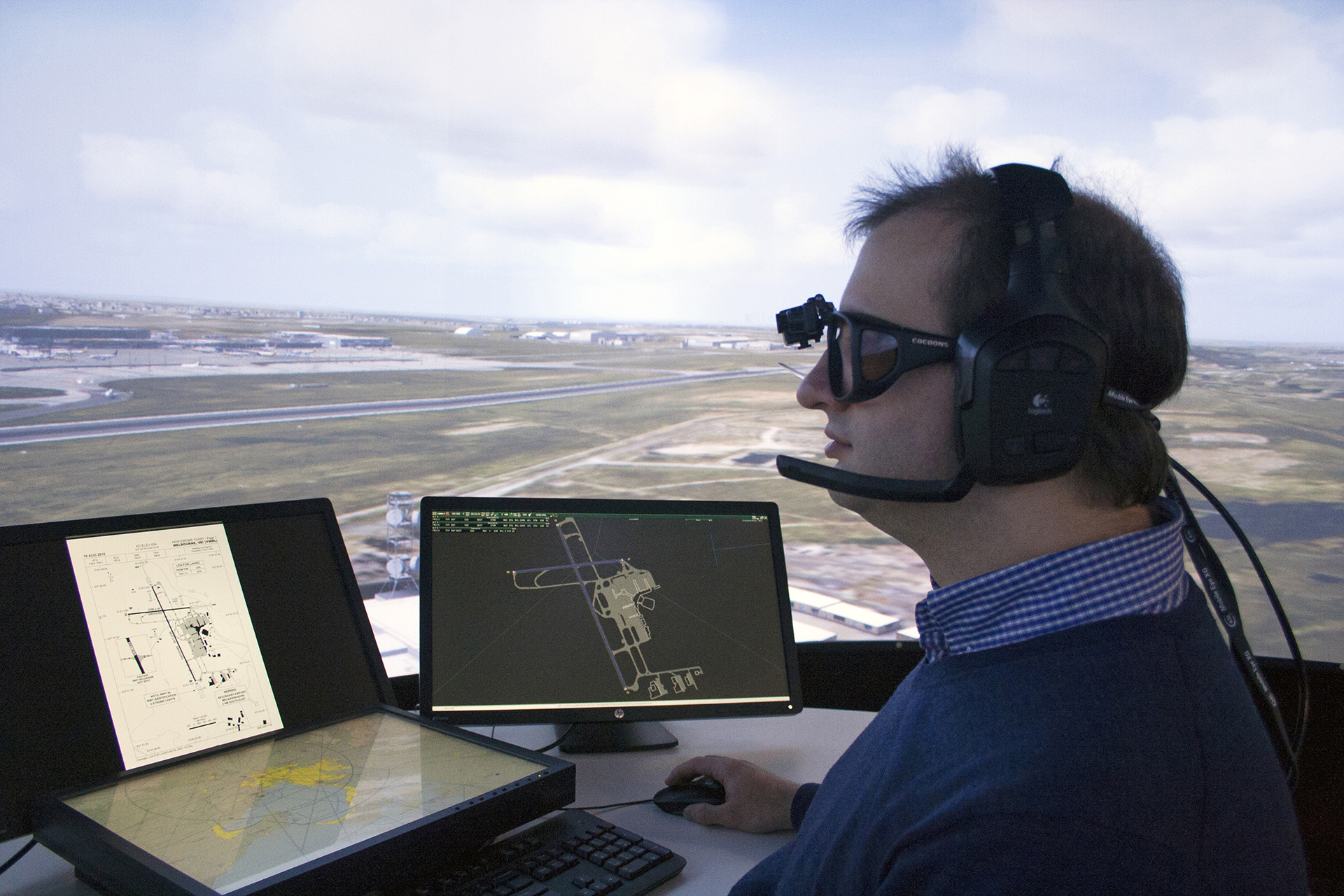 Researcher in the air traffic control simulator wearing eye-tracking glasses.