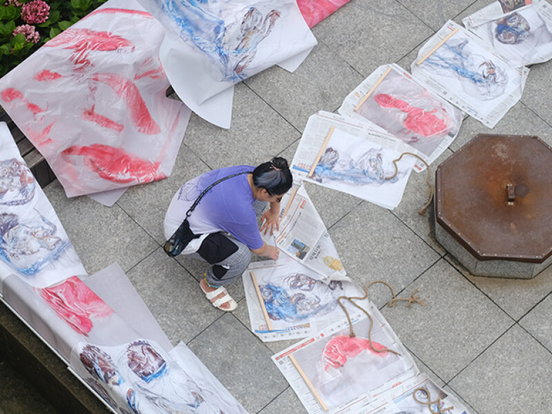 Artist working on art pieces outside