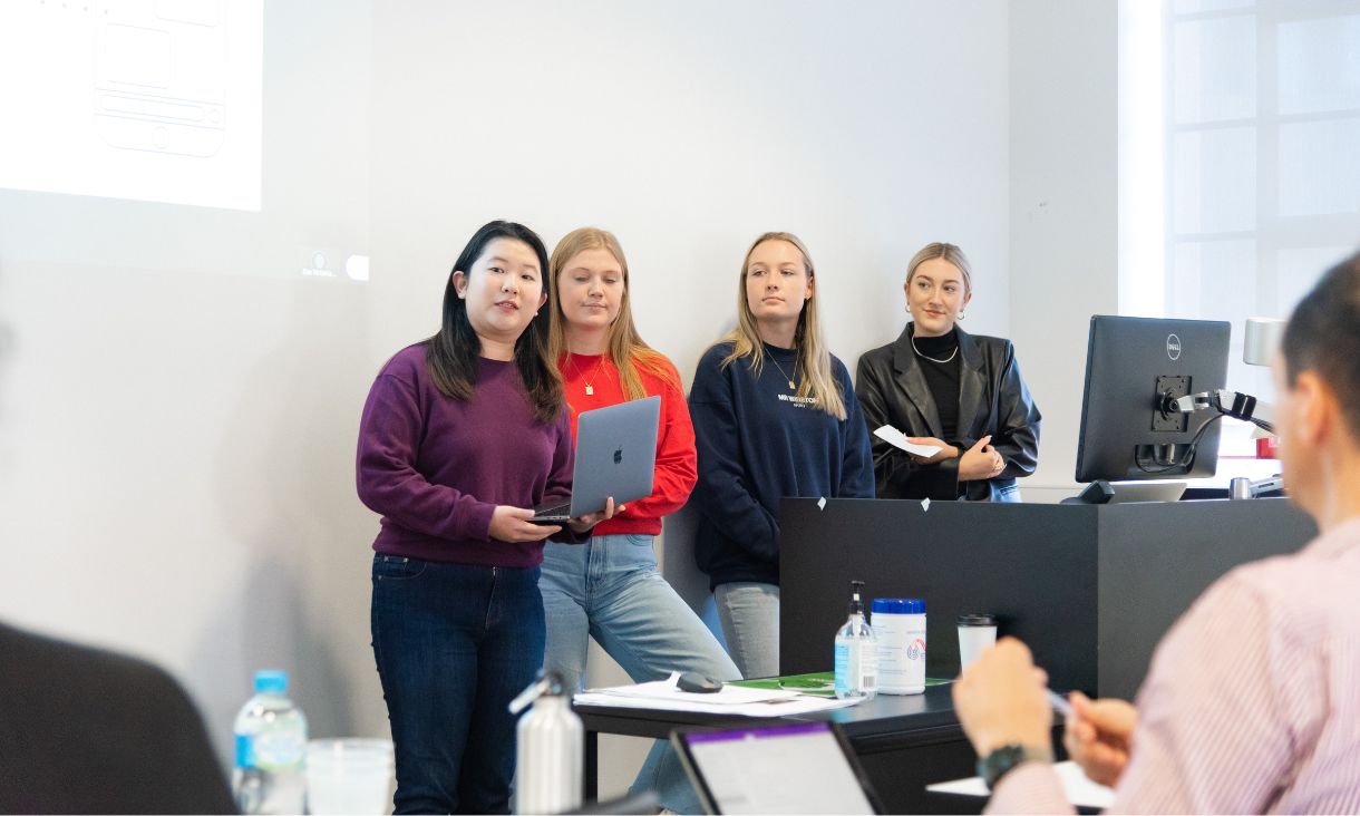 four females presenting in class