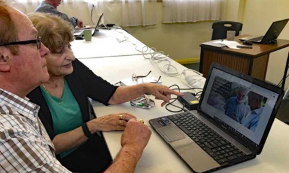 Older adults learning on laptop