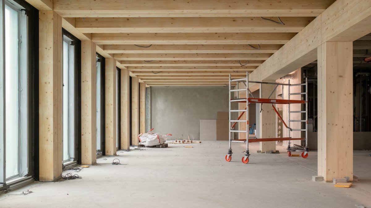 An indoor view of a construction site using timber within a concrete structure.
