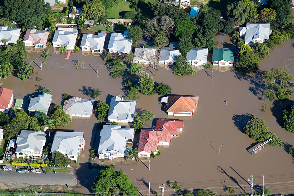 image of brown flood water inundating houses