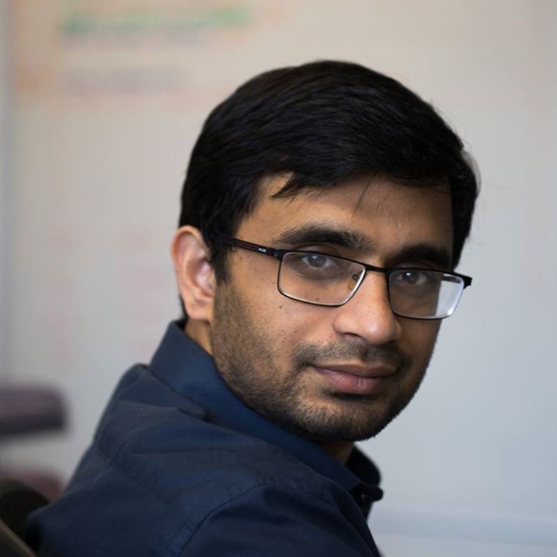 Profile photo of Auvi Tehzeeb. Auvi is sitting inside a room (out of focus), looking at the camera and smiling.
