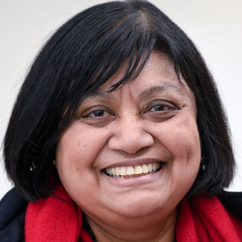 Profile photo of Professor Dayanthi Nugegoda. Dayanthi is standing in front of a grey wall, looking at the camera and smiling.