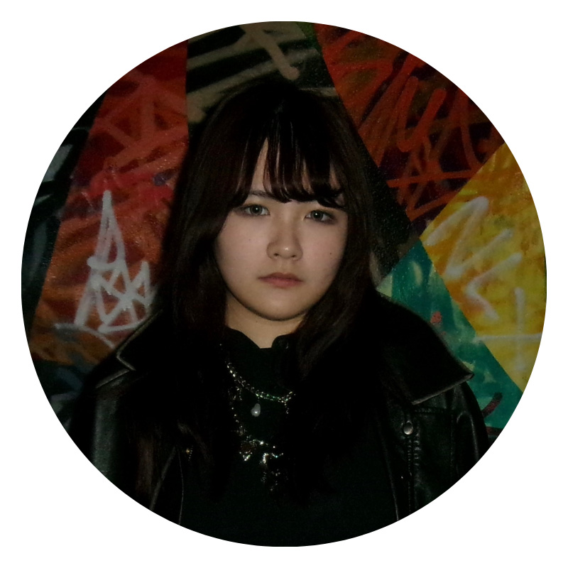 Female student with black hair looking at camera.