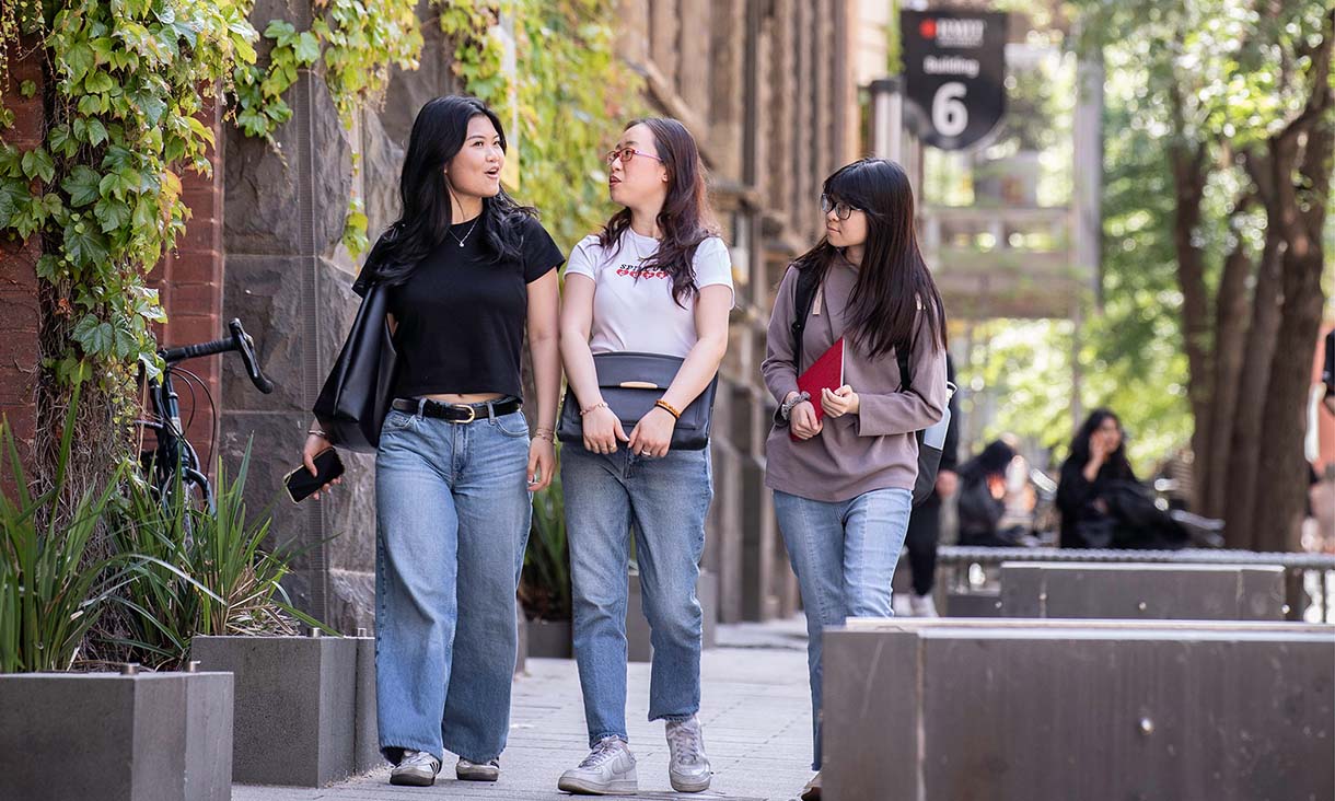 Three RMIT international students walking down Bowen Street