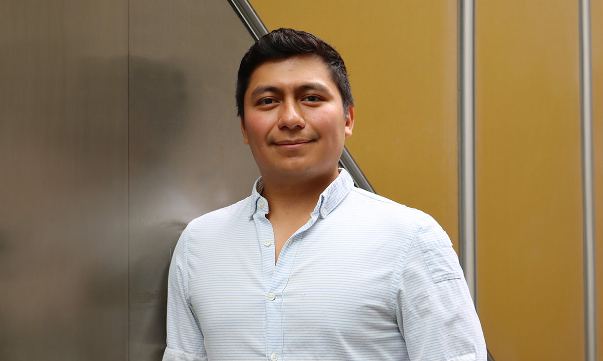 RMIT UP Student Carlos Fuentes leaning against a wall and smiling