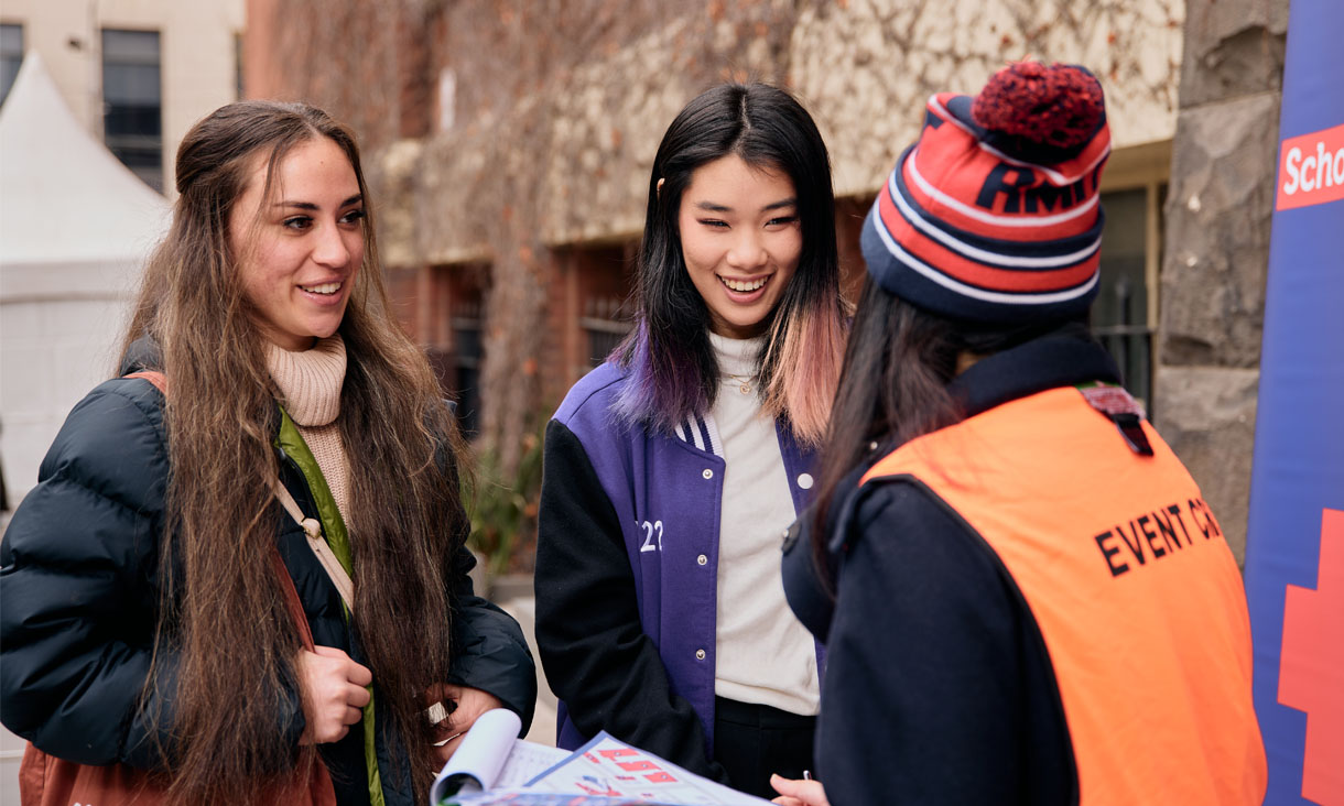 Two students at RMIT Open Day talking to a student ambassador