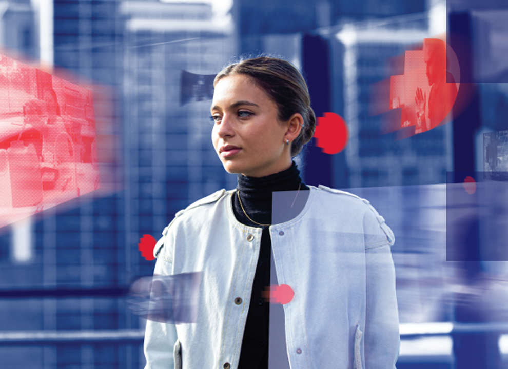 female student looking into distance surrounded by floating RMIT pixels