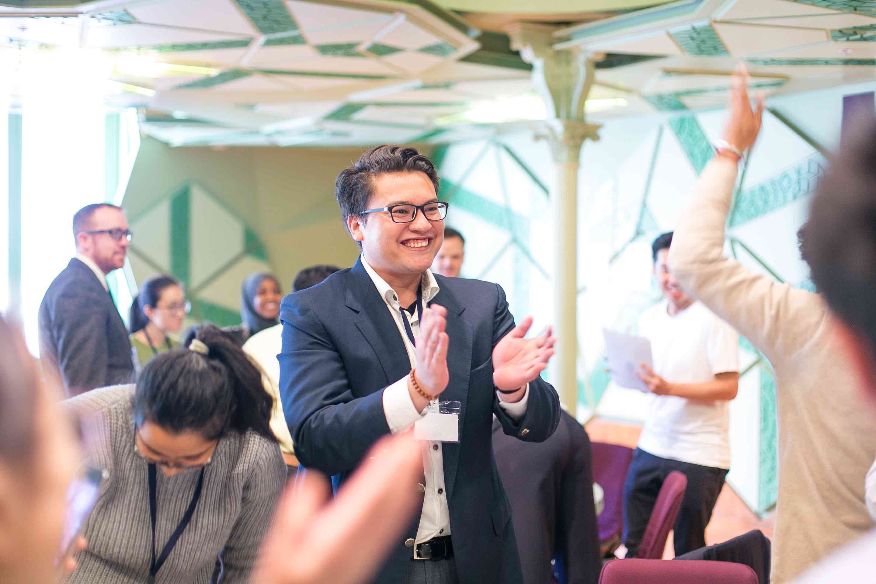 A student at an event claps.