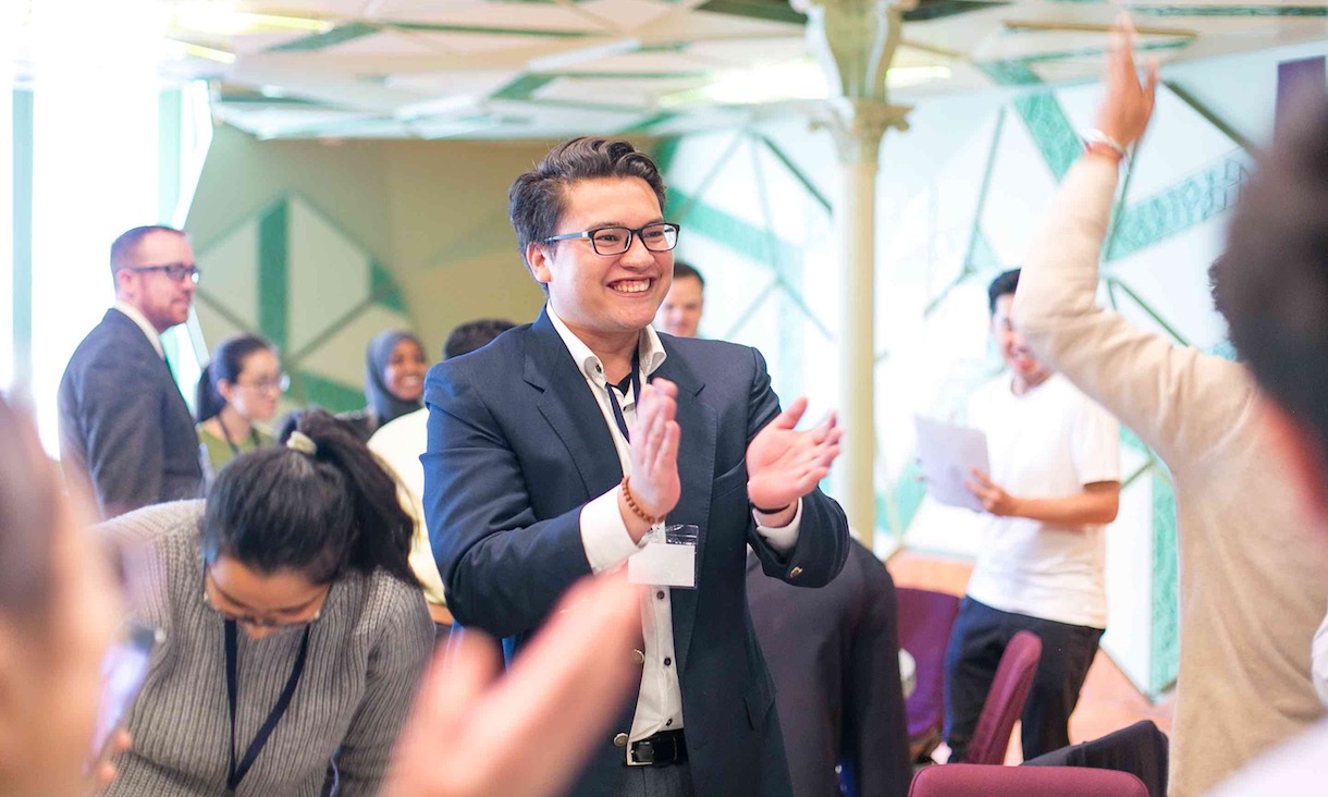 A student at an event claps.