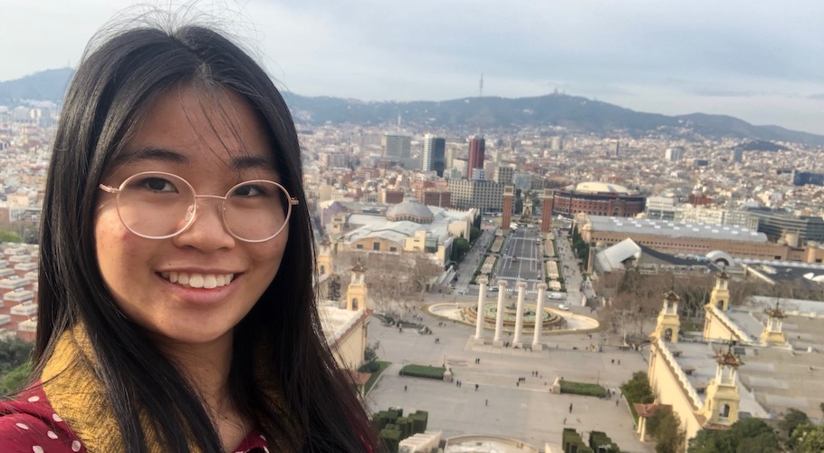 Celeste poses for a photo in front of the Spanish cityscape.
