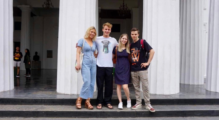 Photo of Keira and other students in front of building with columns