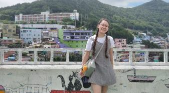 Nicole poses for a photo in front of the Korean cityscape.