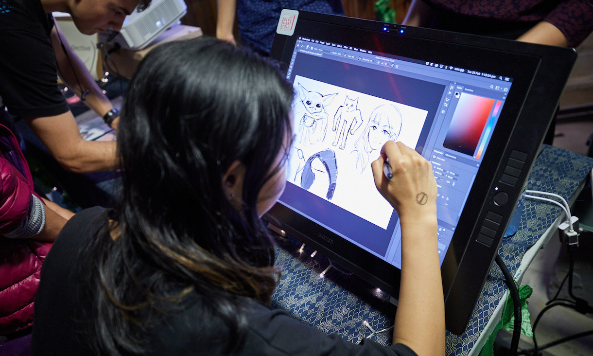 A student creates graphic artwork on a tablet.