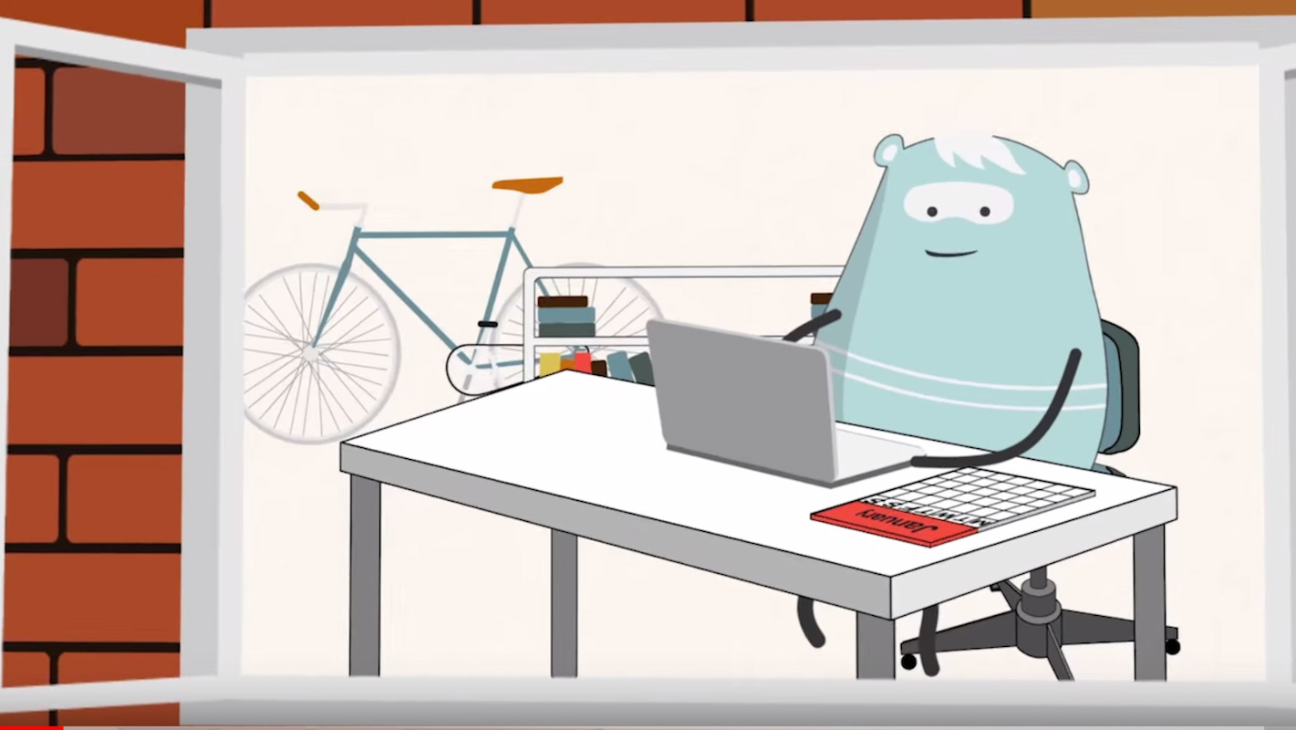 Animation with blue bear sitting at a desk with laptop computer and calendar.