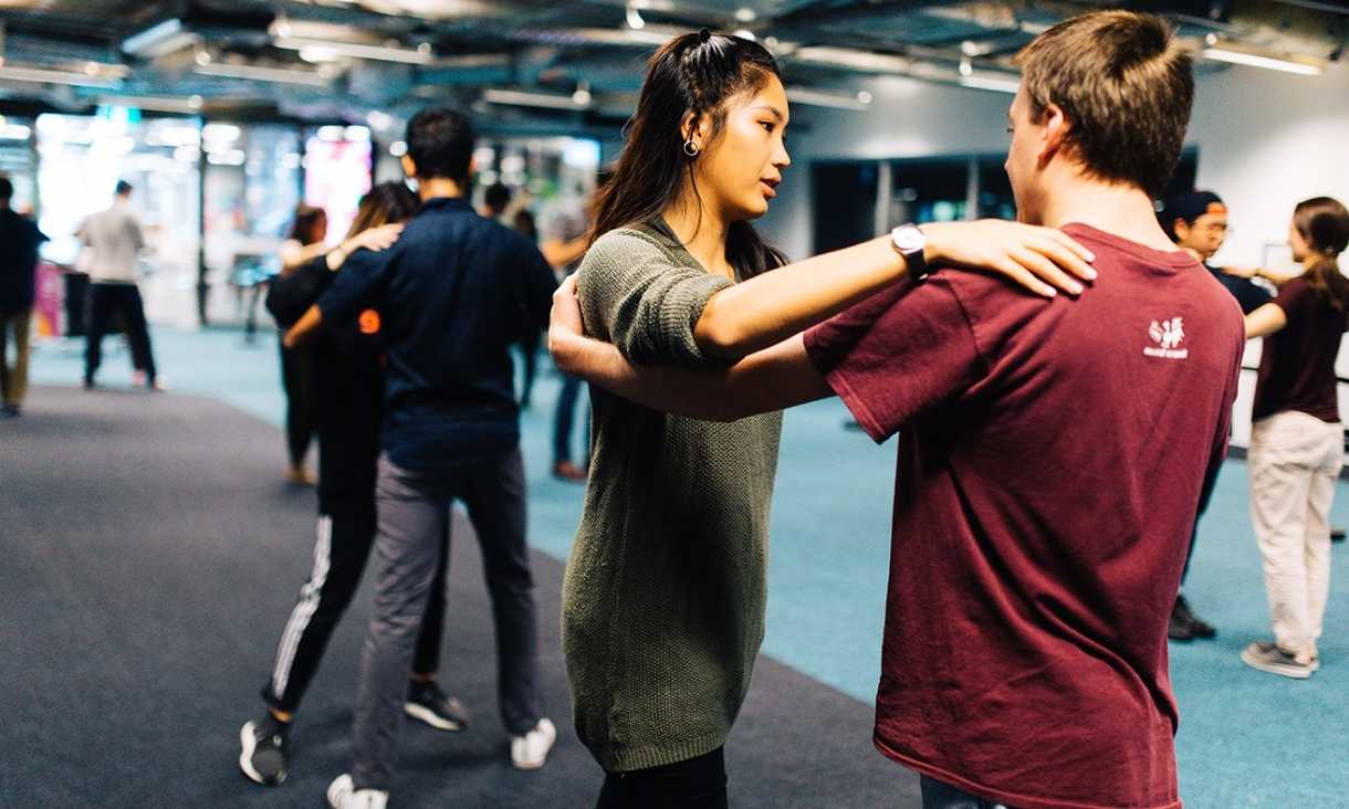 Students take a ballroom dancing class.