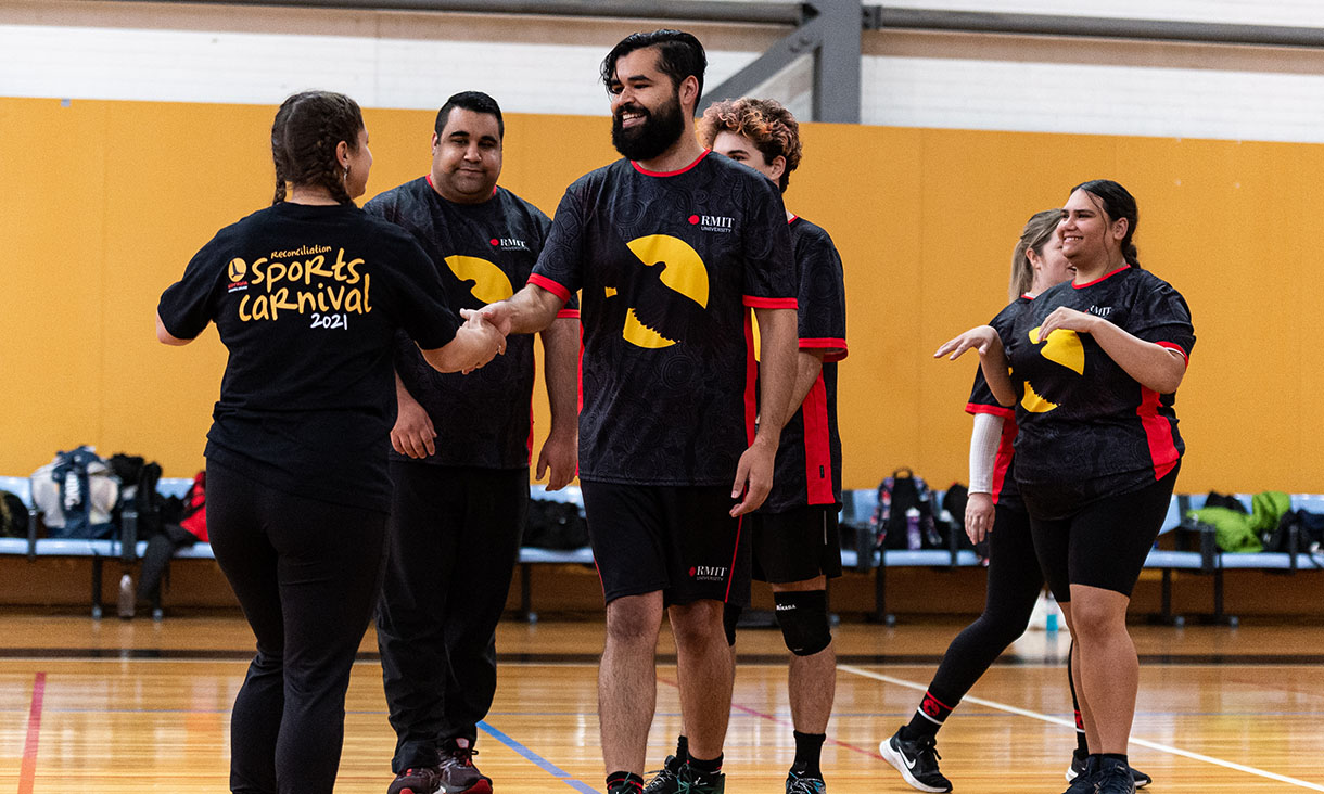 Indigenous students congratulating each other after a volleyball match