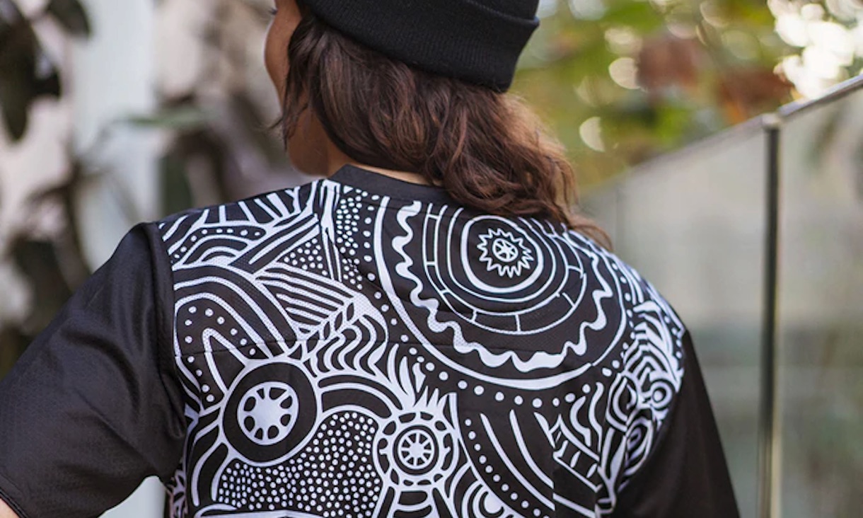 The back of a T-shirt decorated with a black and white design.