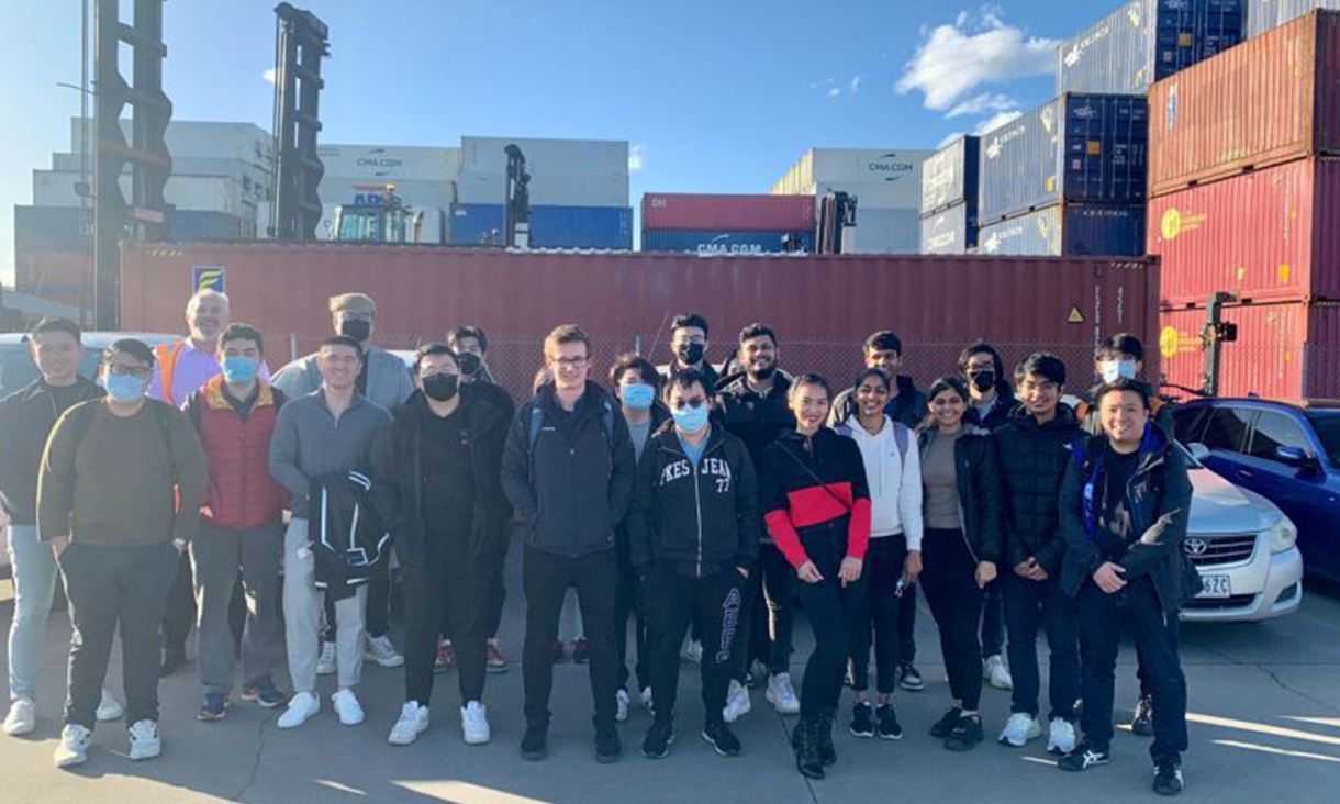 Group of students in front of a shipping depot