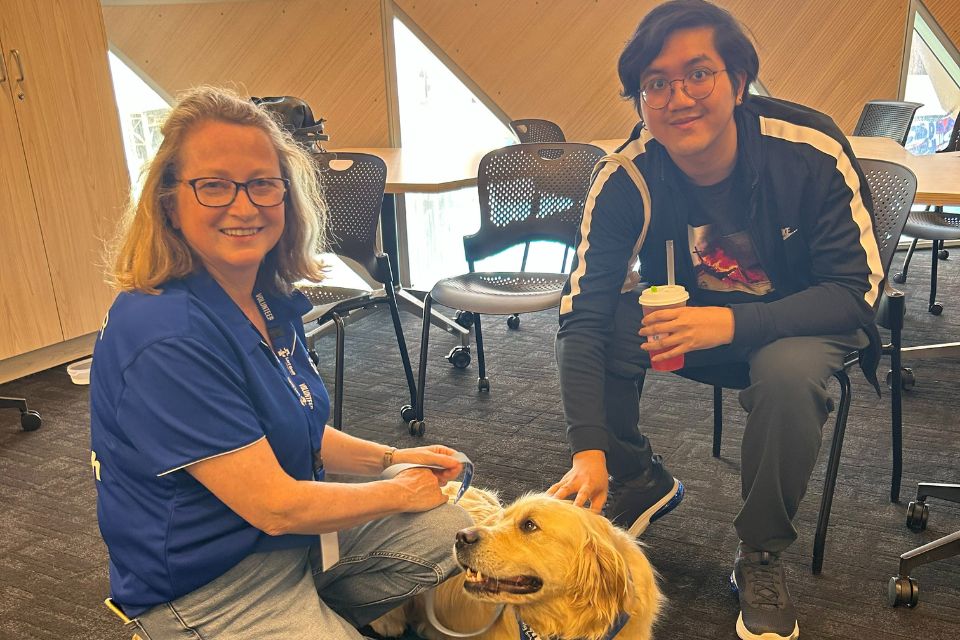 Sila interacting with therapy dog during the study break session 