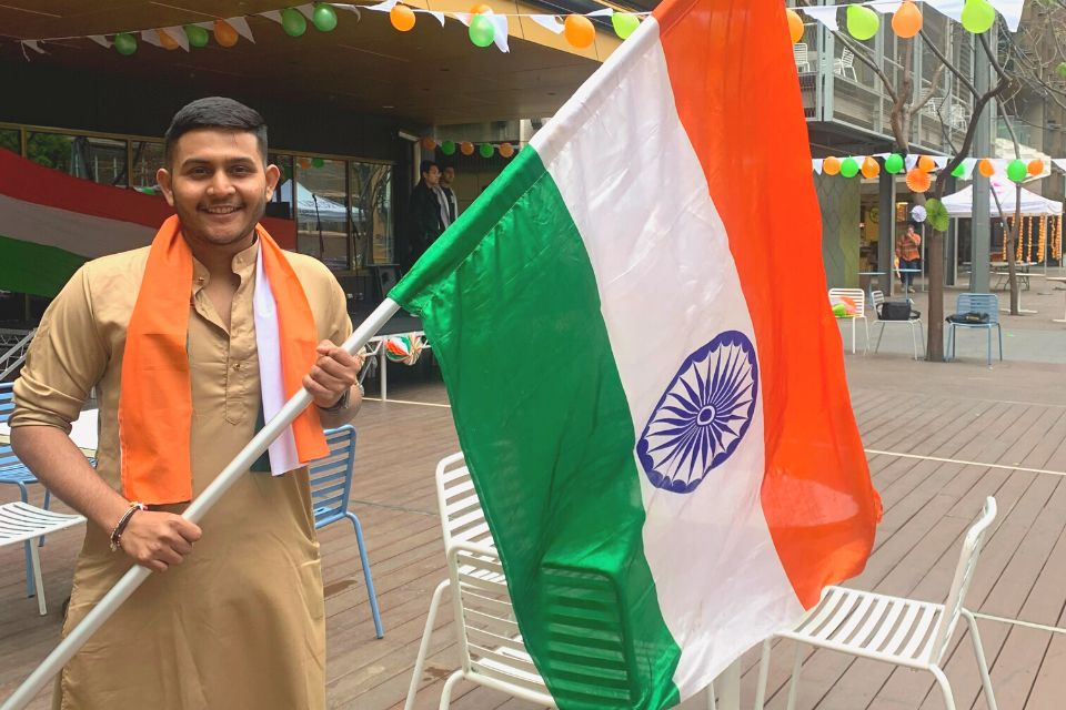 Tanay Shah - Vice president of RMIT Indian Club, smiling with the Indian flag