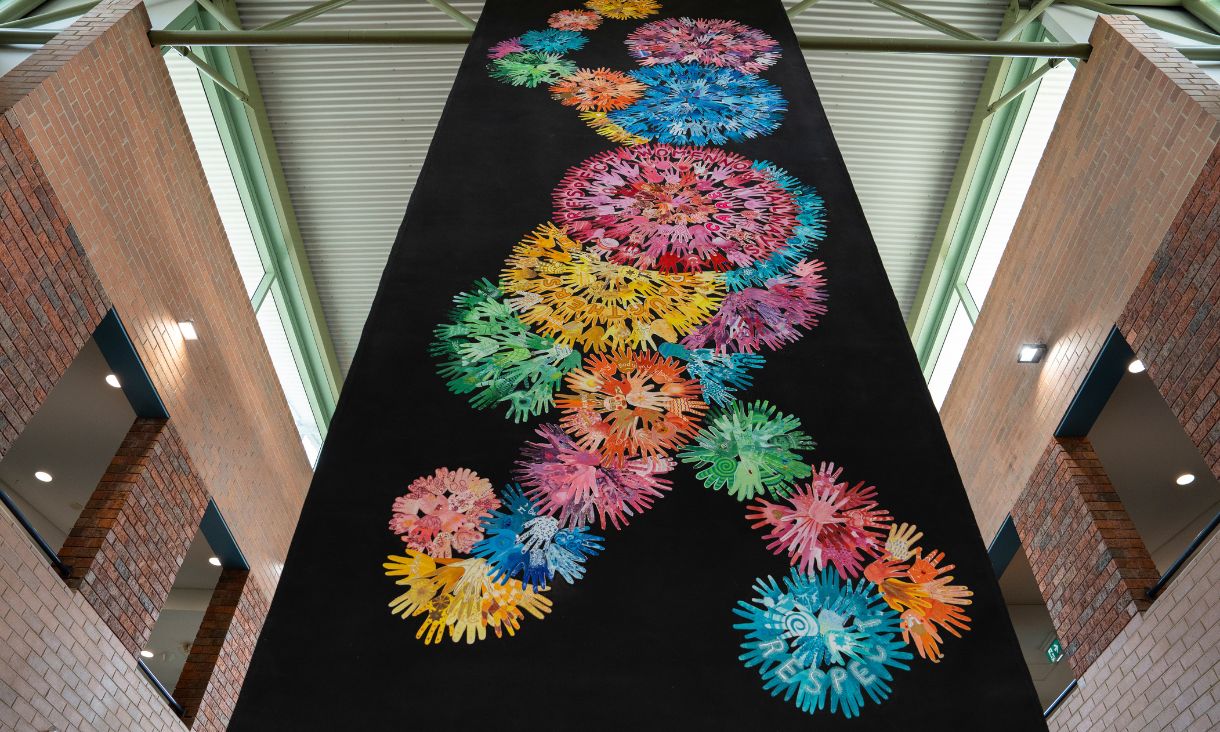 Photograph showing large colourful banner hanging from ceiling in Brusnwick campus