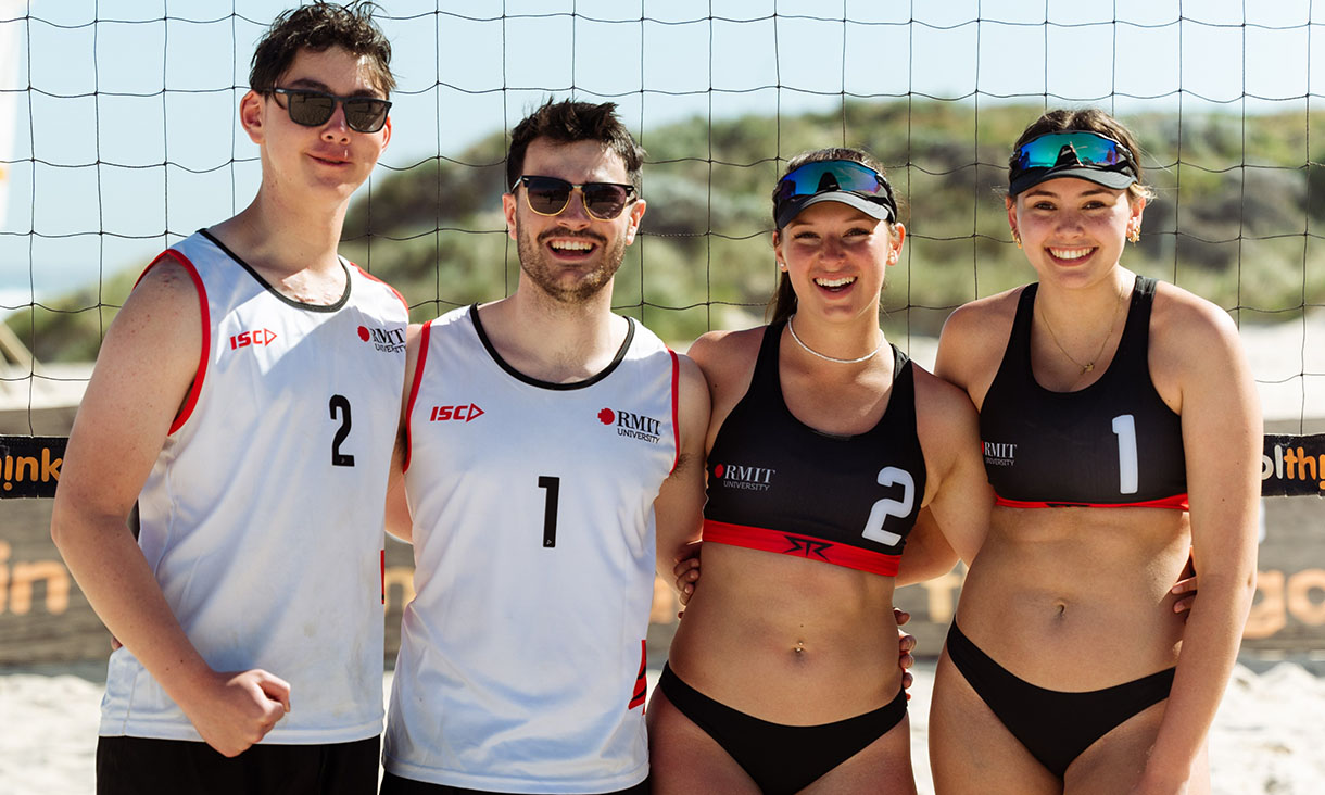 Four people in front of a volleyball net
