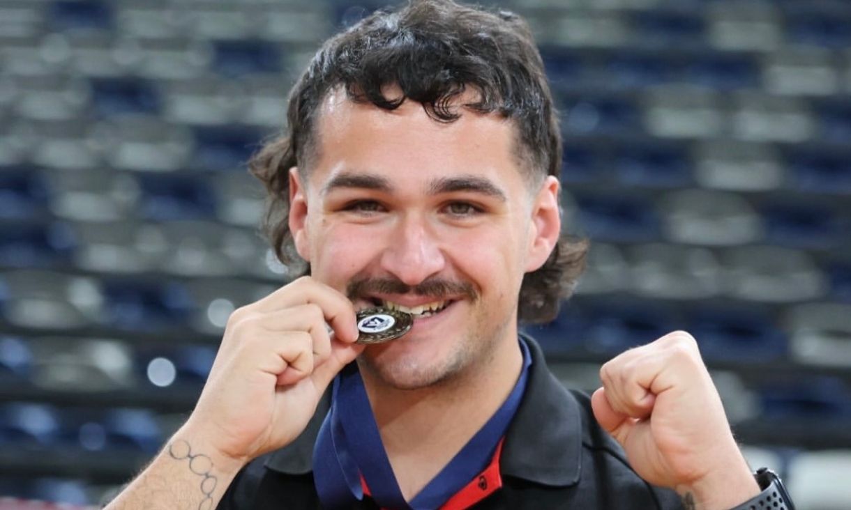 Person biting medal 