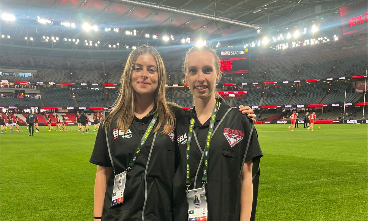 Two people standing on football field
