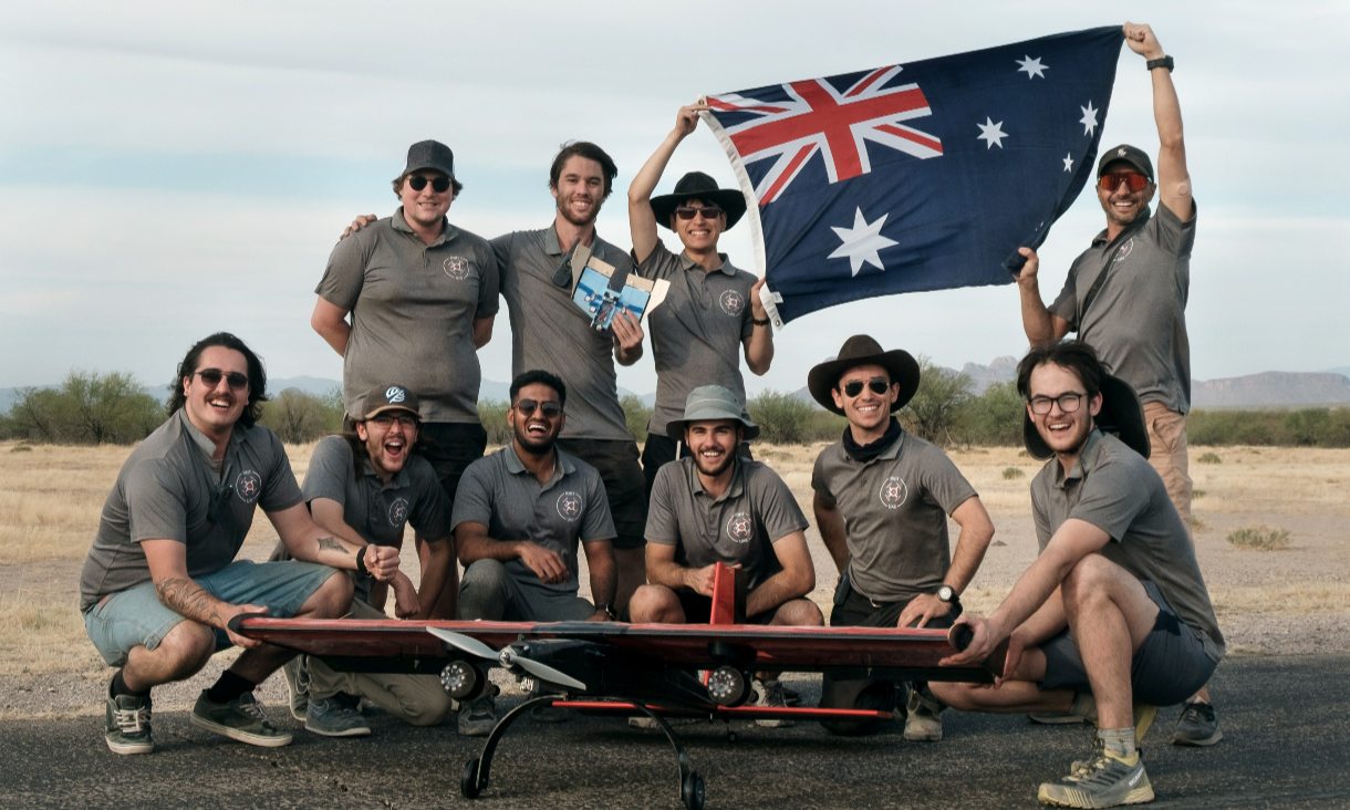 The whole team on the day of the competition standing outside with the aircraft.
