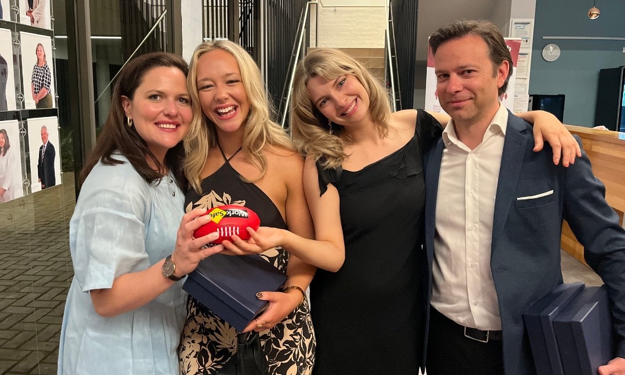 Four people smiling at camera