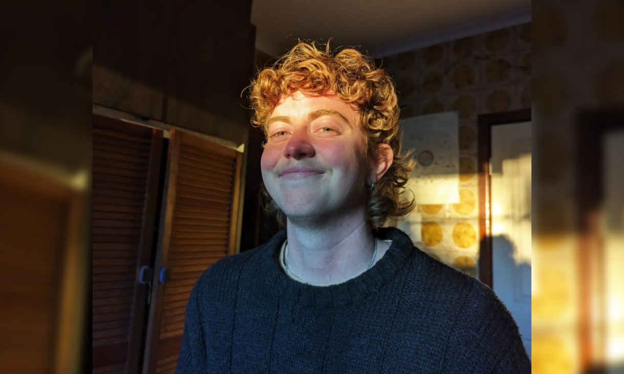 Person from chest up in room smiling with sun on face