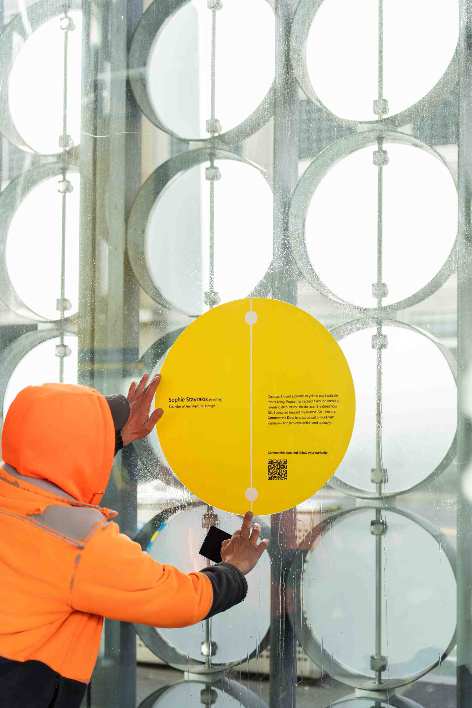 Sophie Stavrakis yellow dot artwork being installed on the RMIT Design Hub's walls