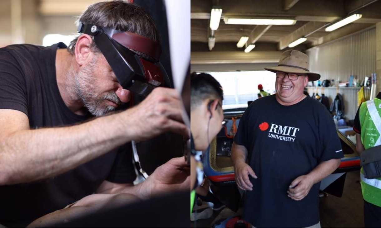 Two people working in car garage