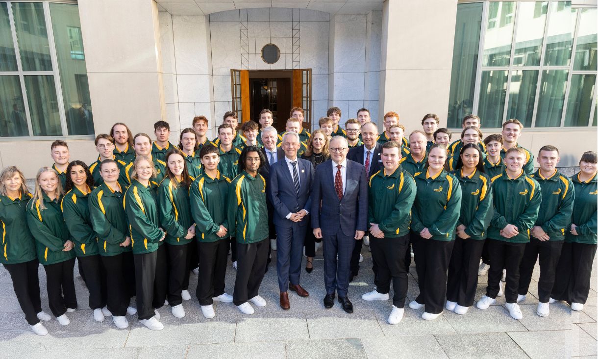 Group of people standing outside parliament house smiling