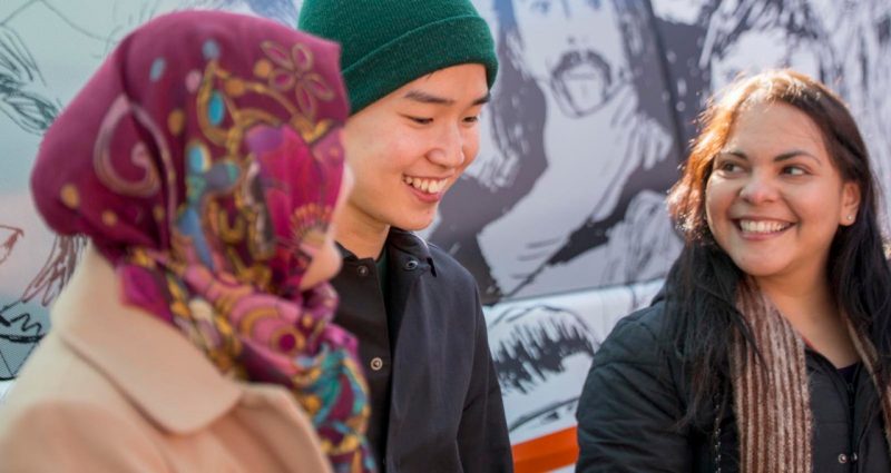 Student wearing a beanie smiling