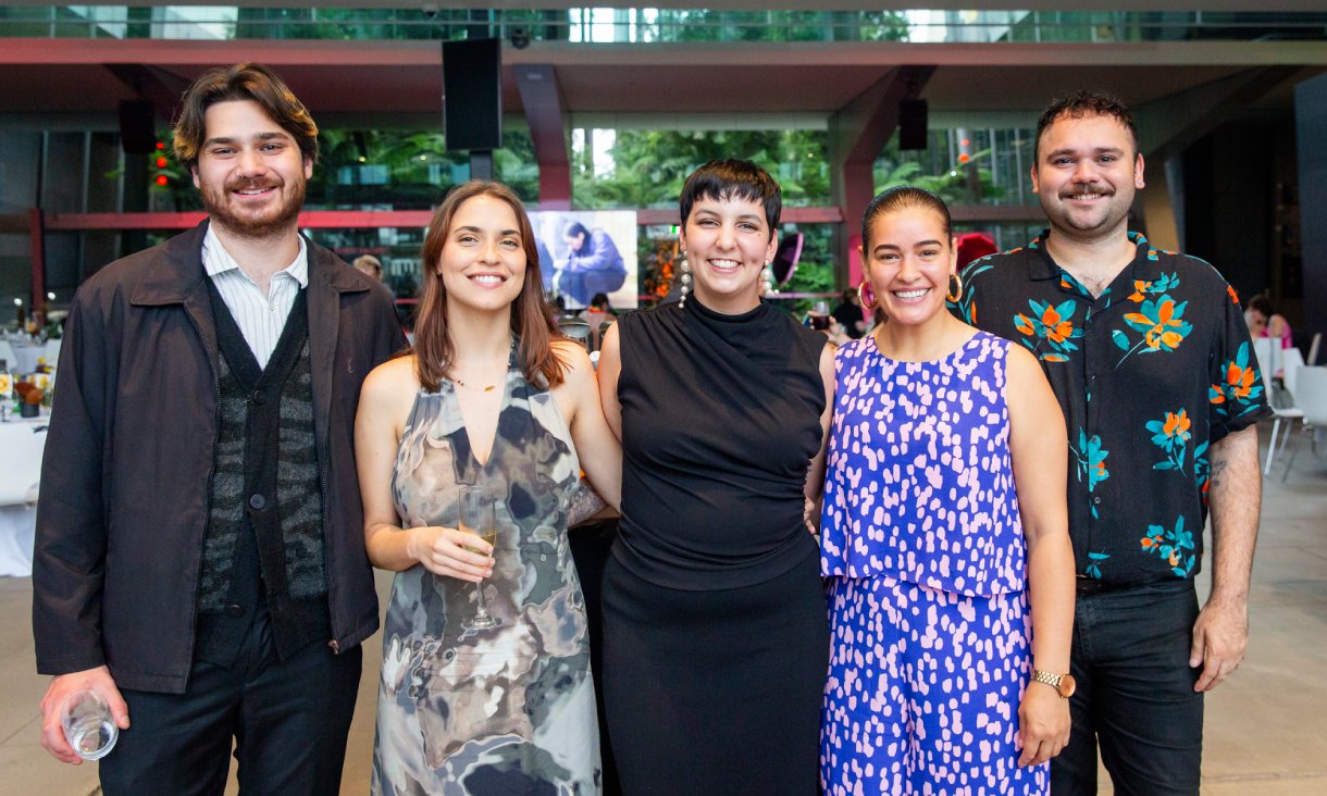 Five people smiling at camera