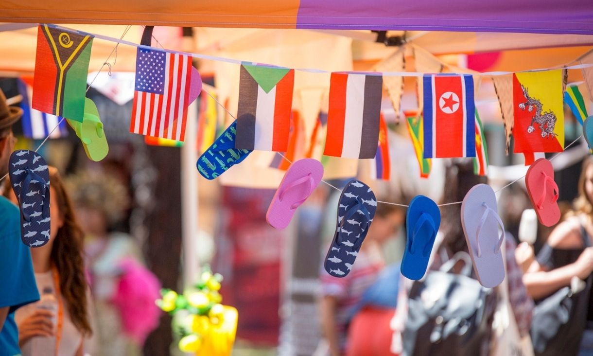 Flags from various countries hanging on a stall.
