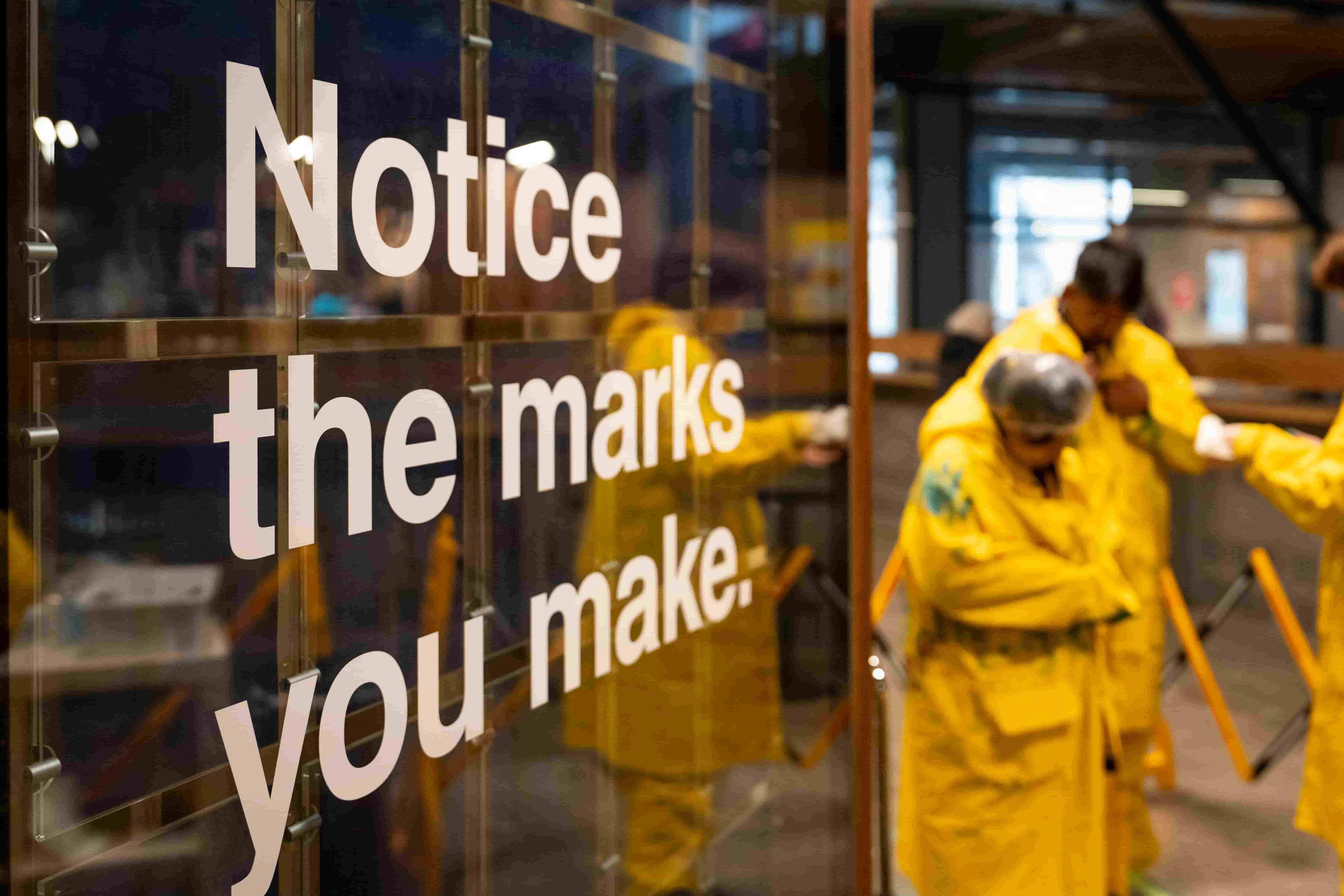 Colourful Mapiyal sculpture with greenery behind.