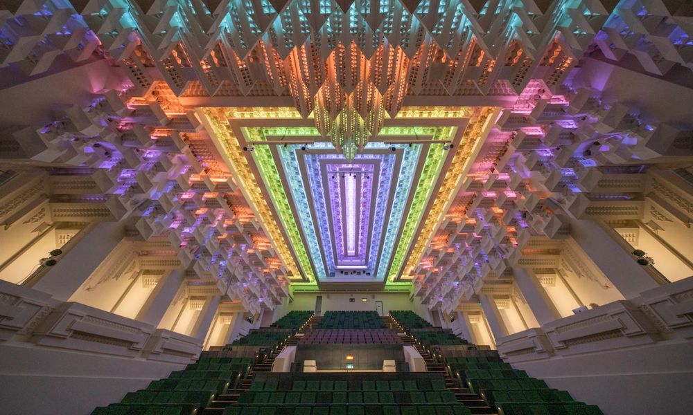 The ceiling of The Capitol theatre. The lighting is rainbow colours and the moulding is shaped like icicles.